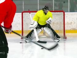 HD:M.S.Shot of Hockey Player Shooting at Goal Stock Footage