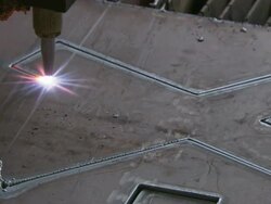 Close Up static - A laser cuts an X into a sheet of steel./Shanghai, China Stock Footage