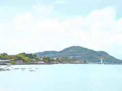 Coast of the island. Fishing village and lighthouse. Stock Footage