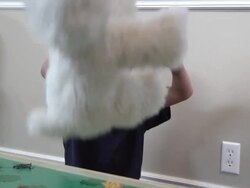 Downs syndrome boy throwing a white stuffed animal. Stock Footage