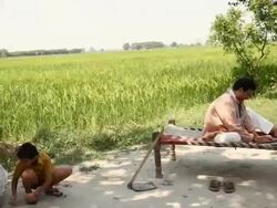 Farmer working on a laptop with his children playing  Stock Footage