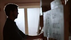 Shop owner hangs price tags on new skateboards in wood studio Stock Footage