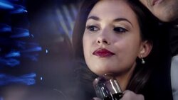 Hollywood starlet stares out at paparazzi and turns to face camera at awards show Stock Footage