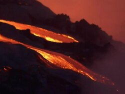 Medium Long Shot static - Glowing lava flows from a volcanic eruption on Hawaii's Big Island. / Hawaii, USA Stock Footage