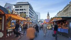 Shoppers move through a Christmas market at golden hour. Stock Footage