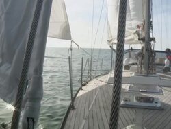 MS TU Pensioner steering his sailboat on calm day / Wismar, Mecklenburg-Vorpommern, Germany Stock Footage