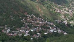 Houses are built on the steep hillsides of a mountain valley. Stock Footage