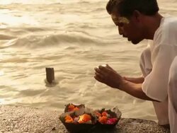 Man worshipping at riverbank, Ganges River, Haridwar, Uttarakhand, India Stock Footage