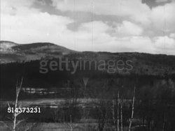 1952: CANADA: BORDER CROSSING: MS Directional sign 'Canada/USA', HA Ws REVERSE PAN Wooded countryside, mountains. WS Canadian man in single horse wagon pulling up under 'Customs & Immigration' sign speaking to border guard, driving away. Instructional Video