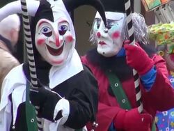 MS Shot of three masked people walking on street in Basel Carnival (Basler Fasnacht) / Basel, Switzerland Stock Footage