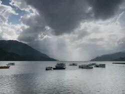T/L stormy clouds over boats on the Pokhara lake, Himalayas Stock Footage