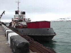 A small ship at the port of Barentsburg, a Russian mining settlement on Svalbard archipelago Stock Footage