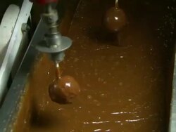 Medium static - Mechanical arms dip apples into caramel /  Missouri, United States Stock Footage