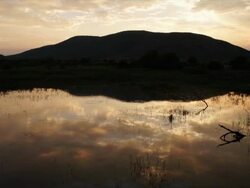 WS View of Clouds reflecting in water at sunset / Pilanesberg National Park, North West Province, South Africa Stock Footage