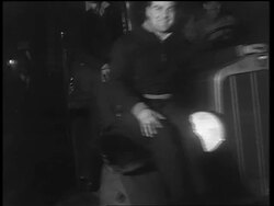 B/W 1933 smiling men sitting on truck slowly driving past camera / end of Prohibition Stock Footage