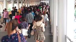 Huge crowds of people walk on the way to Sky train, Subway, or Metro station in Bangkok Stock Footage