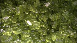 A metal scoop scoops green gummie bears from a candy bin. Stock Footage