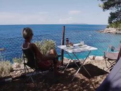 WS DS Woman Having Breakfast In The Camp Stock Footage