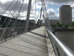 MS People walking on Hungerford Bridge over Thames river / London, United Kingdom Stock Footage