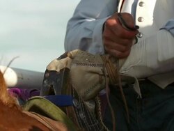 A cowboy clings to the saddle of his horse before going to his rodeo Stock Footage