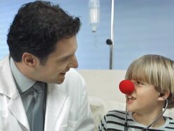 HD: Red Nose Doctors Entertaining A Child Stock Footage