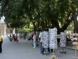 Books on Communism for sale in Plaza de Armas in center plaza of Havana Cuba with tourists Stock Footage