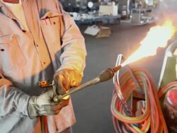 Caucasian worker lighting acetylene torch Stock Footage
