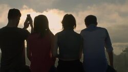 Group of friends hug and take smartphone photos overlooking Austin, Texas skyline Stock Footage