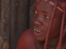 CU Shot of woman preparing herself and putting make up on her body in her hut / Imba Village, Namibia Stock Footage