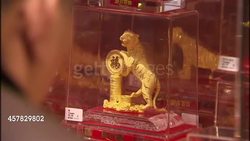 Gold ornaments on display in busy jewellery shop News Clip