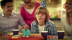 SLO MO blowing out the candles for tenth birthday Stock Footage