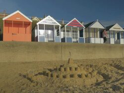 Southwold,colourful beach huts,Jogger,sandcastle,MS, Stock Footage