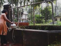 woman lifting water from the well Stock Footage