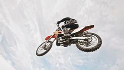 SLO MO Stunt dirt biker jumping over the camera Stock Footage