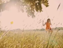 SLO MO Young girl swinging on a tree swing Stock Footage