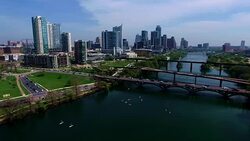 Over Middle of Town Lake Panning Across the City Aerial View Austin Texas Skyline Colorado River Fun Spring water activities Stock Footage