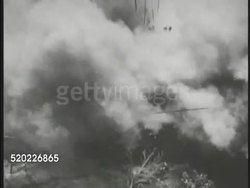 1945: OKINAWA, JAPAN: HA TD US Marines running in field. Bomb explosion. US Marines moving across open field. Pacific Theater, WWII, World War II. Instructional Video