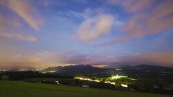T/L day to night timelapse with the milky way above a small German town and the Autobahn Stock Footage