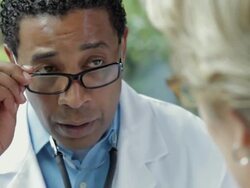 African American doctor examining patient Stock Footage