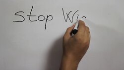 Hand writing a 'Stop wishing start doing' message on a white board using a black marker Stock Footage