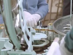 ECU of open olive cans dropping from conveyor into filling wheel at vintage olive processing plant / Ontario, California, USA  Stock Footage