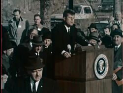 October 9, 1962 WS Spectators and flags/ MS President John F. Kennedy delivering speech at groundbreaking ceremony for 1964 World's Fair in Flushing Meadows/ Queens, NY/ AUDIO Stock Footage