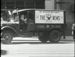 National Recovery Administration signs and posters identify a New Deal government program. News Clip