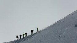 Climbers on the arete leading up from the Vallee Blanche to the Aiguille Du Midi above Chamonix, France Stock Footage