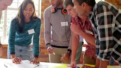 Creative business people reviewing proofs in meeting Stock Footage