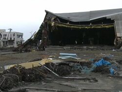 Destruction caused by tsunami after magnitude 9 Tohoku earthquake, north east Japan, March 2011. Industrial warehouse ripped apart by tsunami in Ishinomaki City port, Miyagi Prefecture Stock Footage