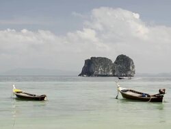 WS View of Long tail boats and Limestone rock in Sea, Marine National Park / Ko Hai, Krabi, Thailand Stock Footage