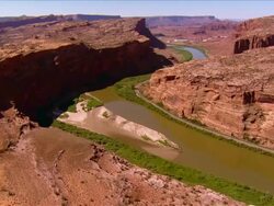 Aerial view over the Colorado River snaking through the Slick Rock Canyons near Deadhorse Point State Park / Utah Stock Footage