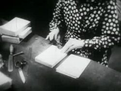 B/W 1934 close up hands of woman stamping books in library in WPA project / documentary Stock Footage