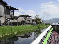 MS POV View of Boat riding along floating village / Ywama, Shan State, Myanmar Stock Footage